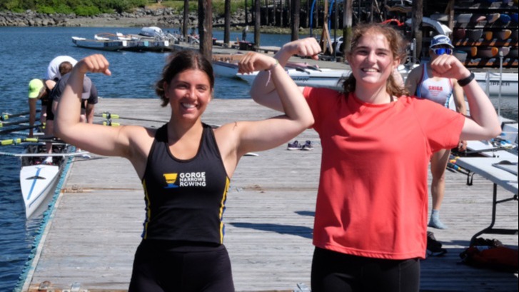 Junior girls flexing their muscles on the dock.